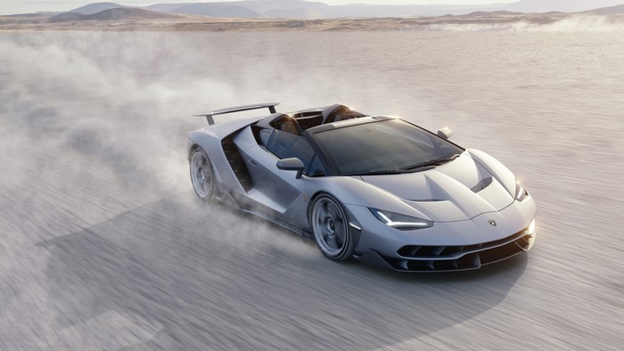 Lamborghini Centenario Roadster driving on a dusty plain