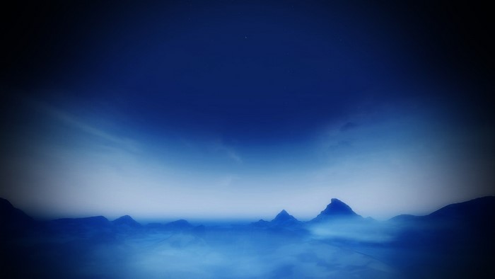 Mountains under a dark blue sky with faint stars