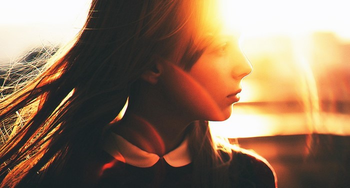 Girl in sunlight with windblown hair