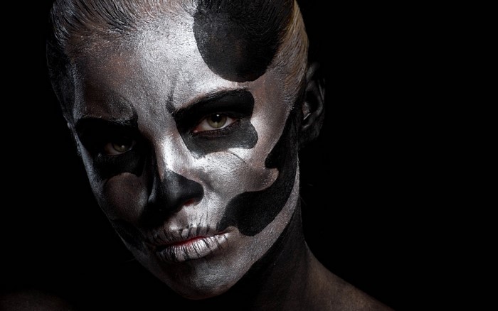 Woman with skull face paint and black makeup