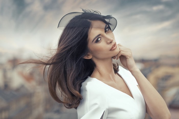 Elegant Woman in White Dress with Flowing Hair