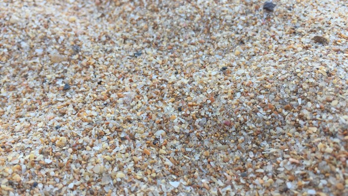 Close-up of sand and small pebbles on a beach