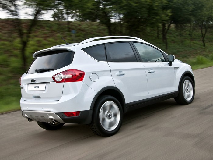 White Ford Kuga driving on a road