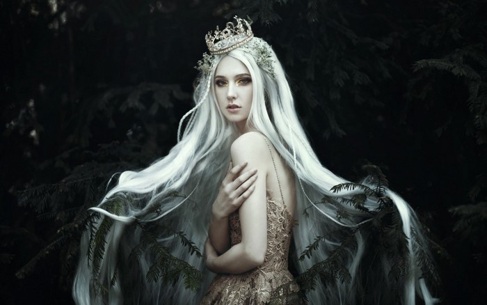Fantasy woman with crown and long white hair in forest