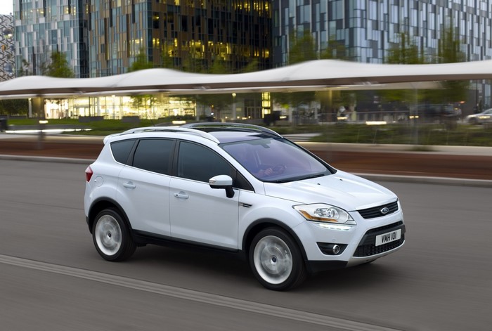 White Ford Kuga driving on a road