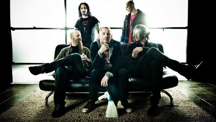 Stone Sour band members sitting on a couch