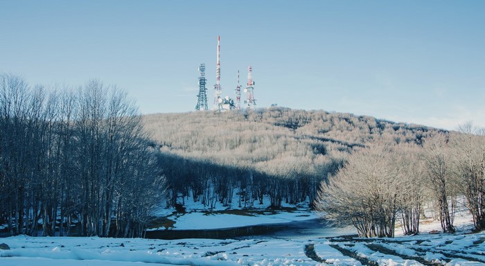 Snowy mountain landscape with communication towers