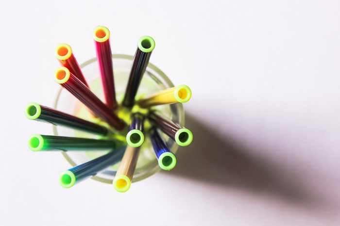 Top view of colorful pens in a glass