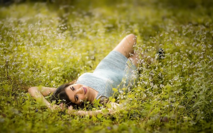 Woman lying in a field of flowers