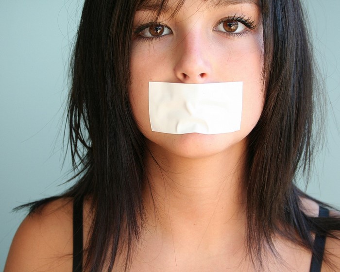 Woman with tape over her mouth
