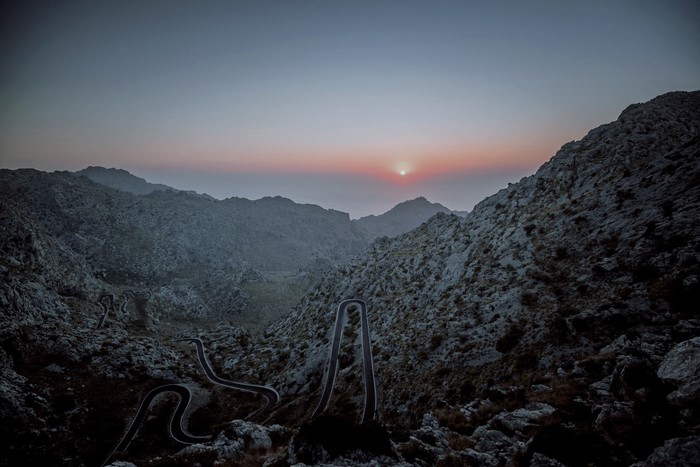 Winding mountain road at sunset