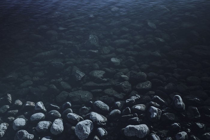 Underwater rocks and water surface