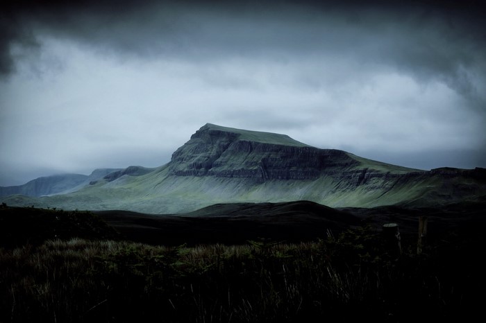 Misty mountains and plateau under dark clouds