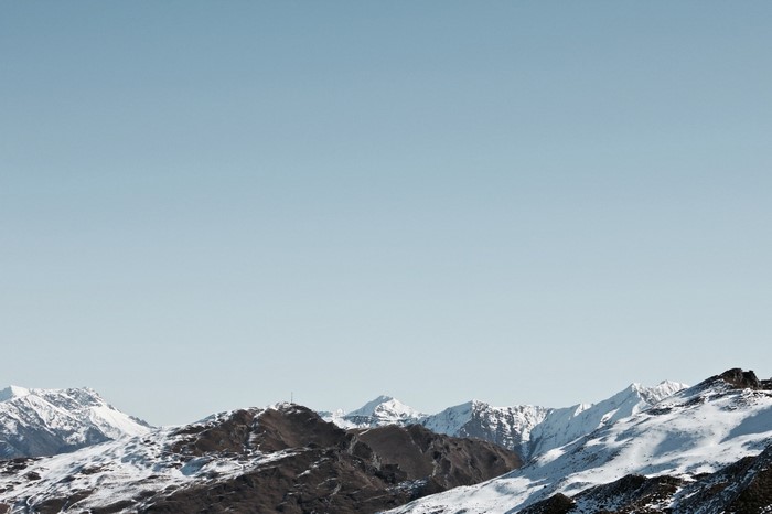 Snow-covered mountains under a clear blue sky