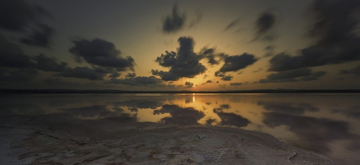 Sunset over a calm lake with reflections