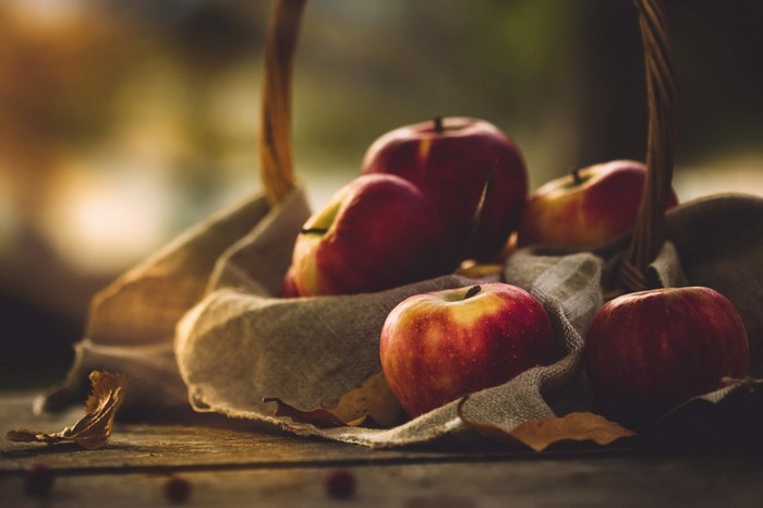 Basket of Fresh Red Apples on Rustic Cloth