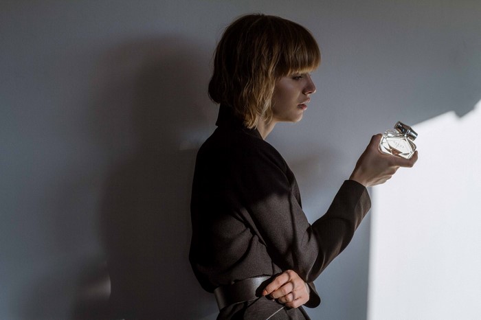 Woman holding a perfume bottle