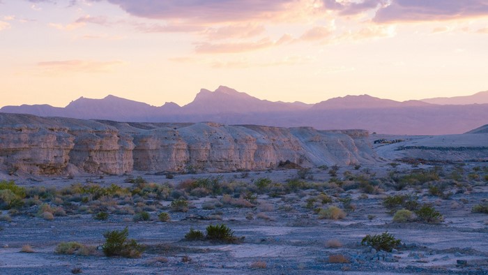 Desert landscape with mountains at sunset