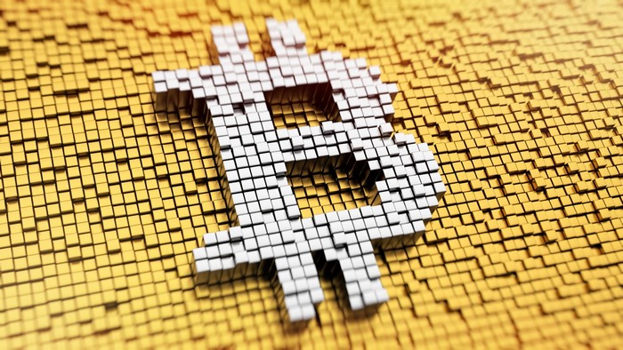 Bitcoin symbol made of cubes on gold background