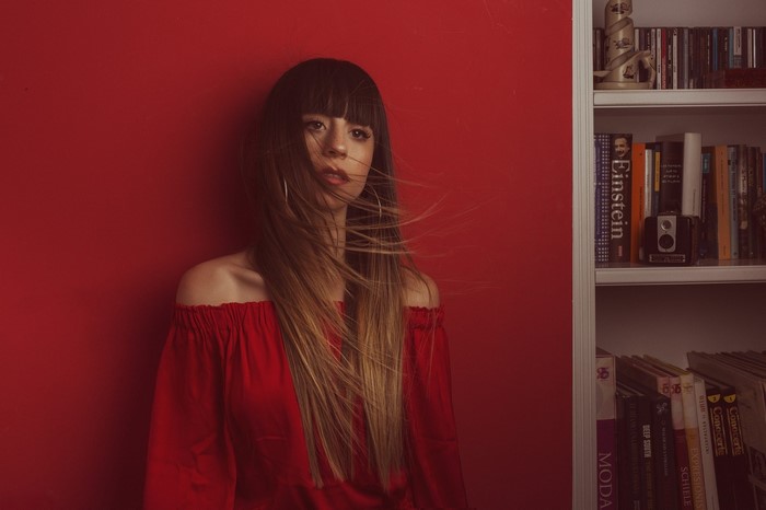 Woman in red dress with windblown hair