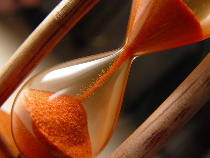 Close up of an hourglass with orange sand