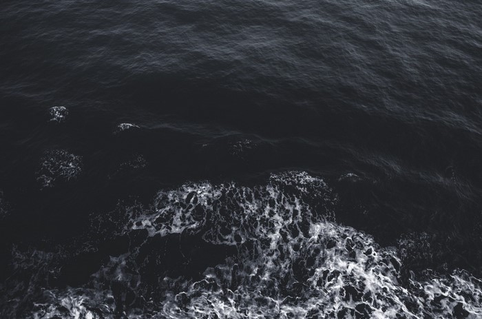 Dark ocean waves with white foam