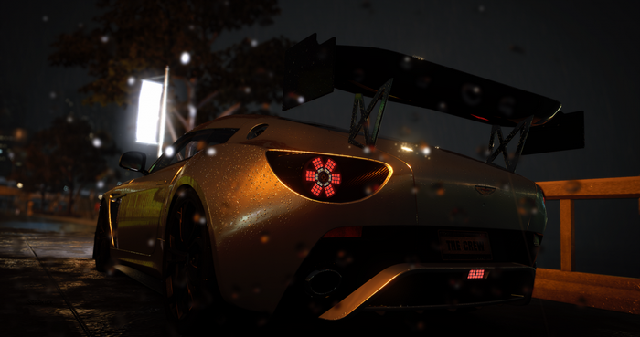 Aston Martin sports car in the rain at night