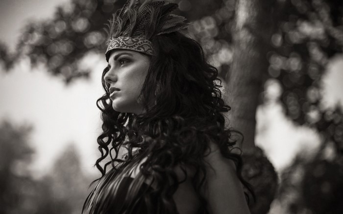 Woman with feathers in her hair, profile view