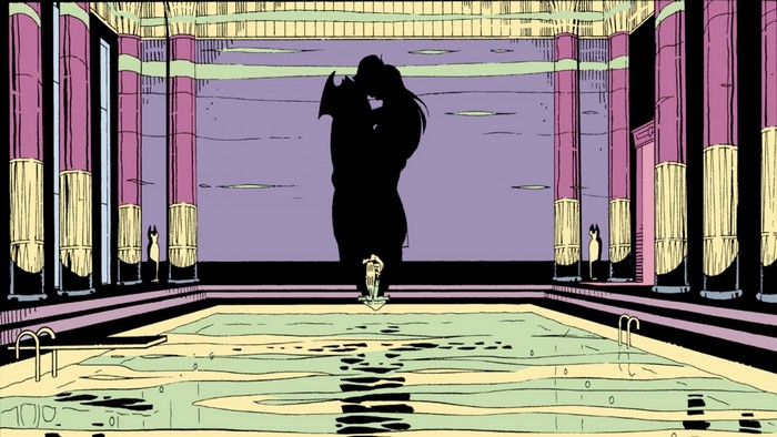 Silhouettes of a couple kissing in a grand indoor swimming pool