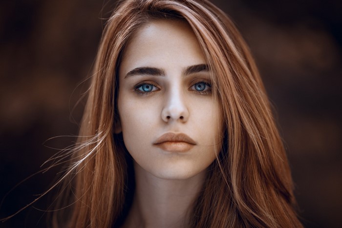 Portrait of a young woman with blue eyes and long hair