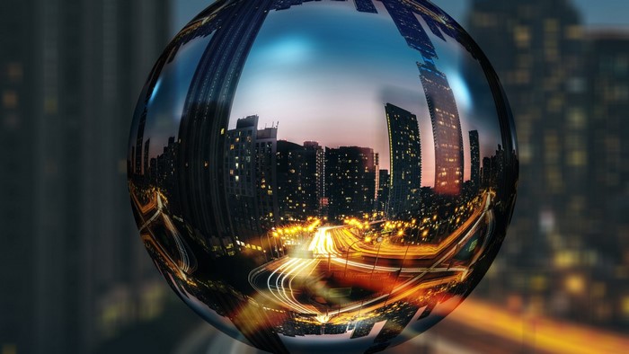 Cityscape reflection in a glass sphere at night
