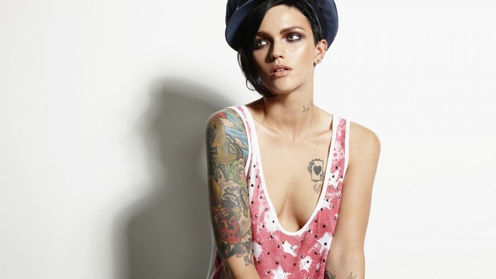 Ruby Rose with tattoos wearing a cap and tank top