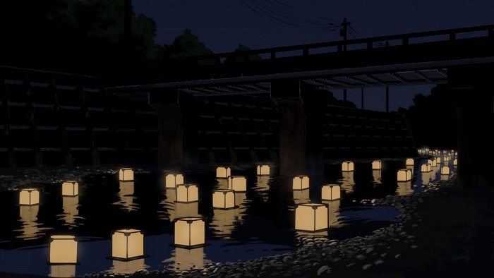 Lanterns floating on a river at night under a bridge
