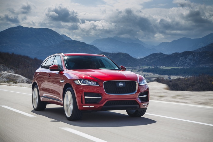 Red Jaguar F-Pace driving on a mountain road