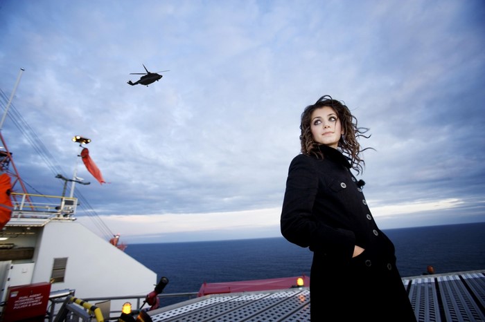 Katie Melua on a ship with a helicopter