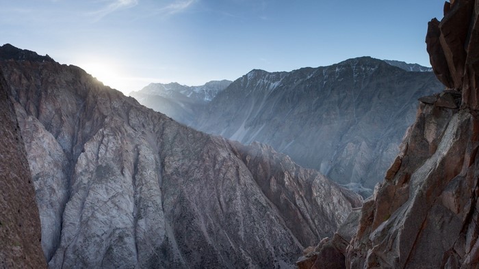 Mountain range with sunlit peaks and rocky foreground