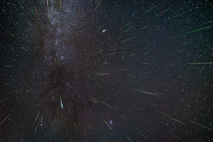Night sky with numerous meteors and the Milky Way galaxy