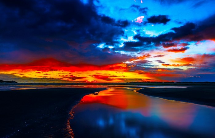 Sunset over a calm body of water with colorful clouds