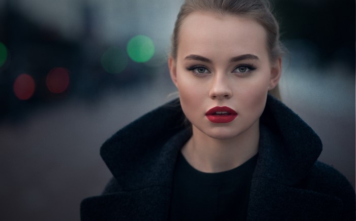 Woman with red lipstick and dark coat