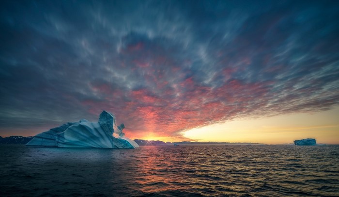 Iceberg at sunset over the ocean