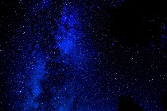 Starry night sky with blue nebula and stars