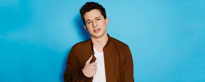 Charlie Puth in a brown jacket