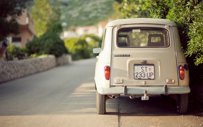 Rear view of a beige Renault 4 GTL parked on a street