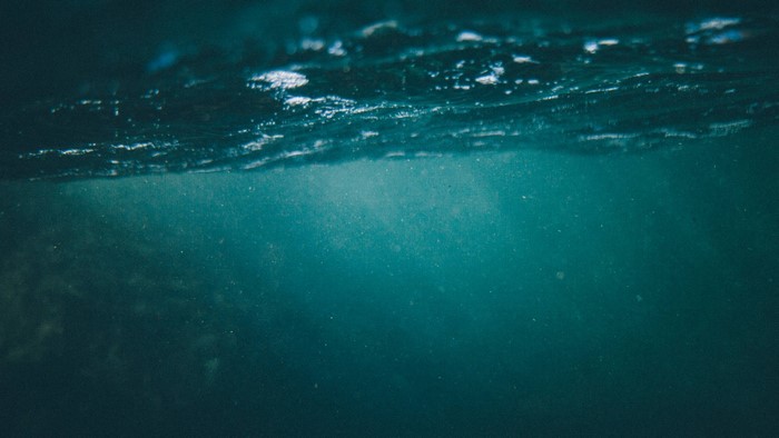 Underwater view of the ocean surface with light rays