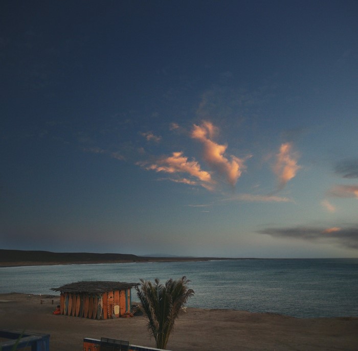 Small hut on the coast at sunset