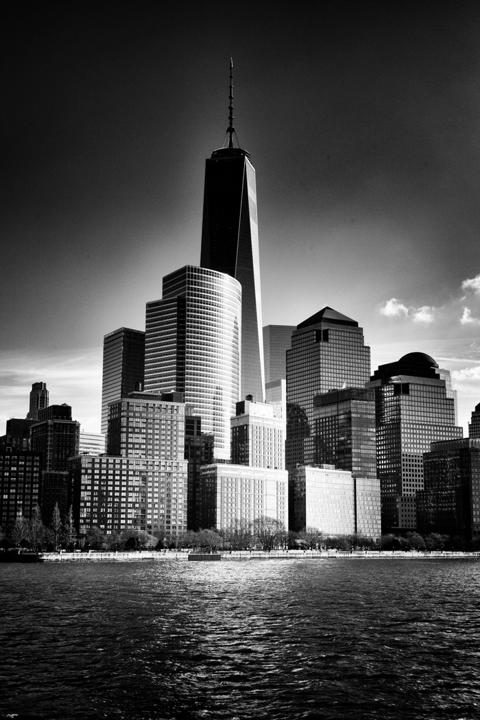 One World Trade Center and New York City skyline over water
