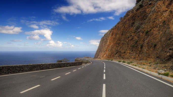 Coastal road winding along a cliff by the ocean
