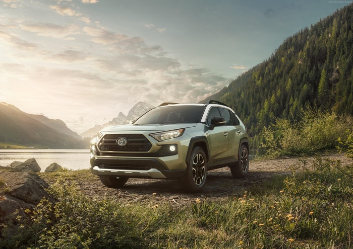 2019 Toyota RAV4 SUV parked by a lake and mountains