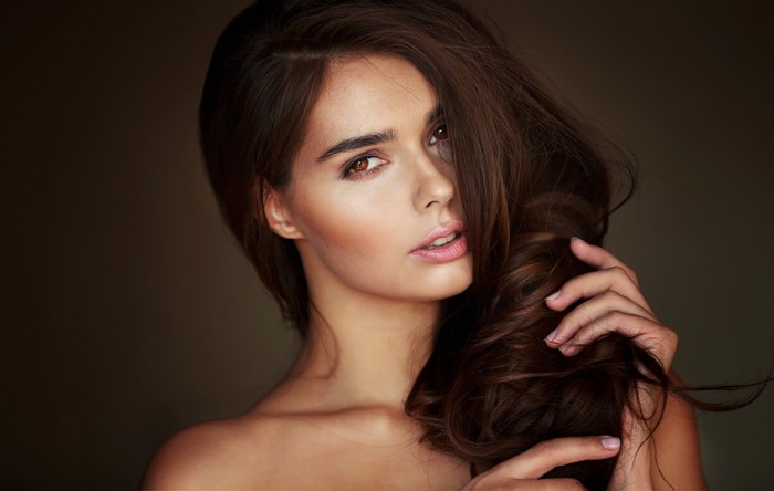 Portrait of a Woman with Long Curly Brown Hair