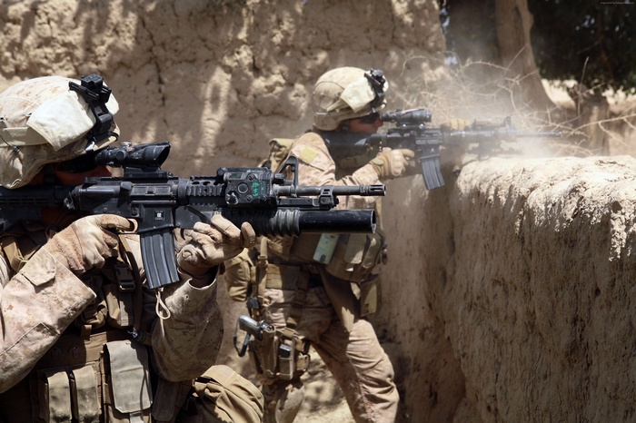 Marines in combat with M-16 rifles